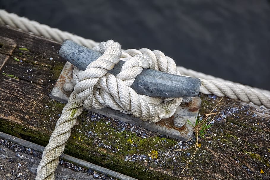 white rope knotted on gray hook, dew, nautical, wood, sea, port
