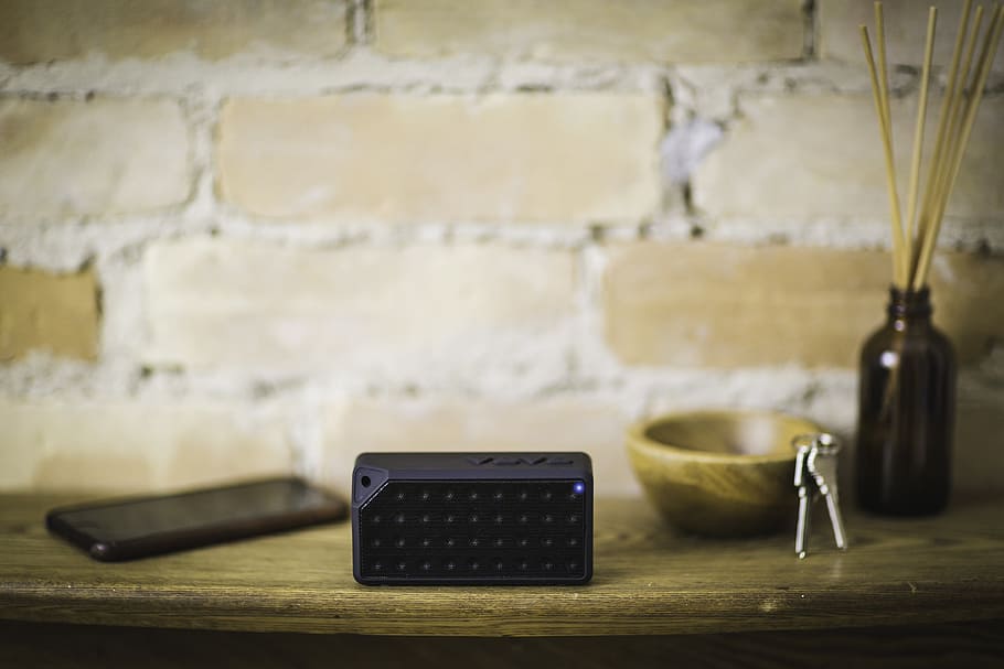 selective focus photography of black cordless electronic device near smartphone on table HD wallpaper
