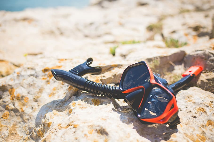 Snorkel and Diving Scuba Mask On a Rock Near The Sea, diving mask