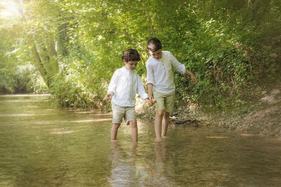 two boy's walking on water, children, river, together, hand, fellow