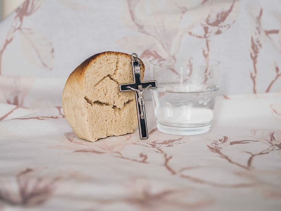 Crucifix pendant on bread beside glass, crucifix pendant beside brea HD wallpaper