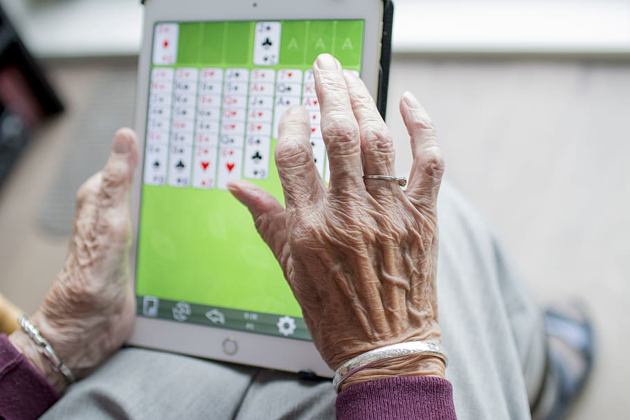 person holding silver iPad, hand, hands, old age, elderly, loneliness