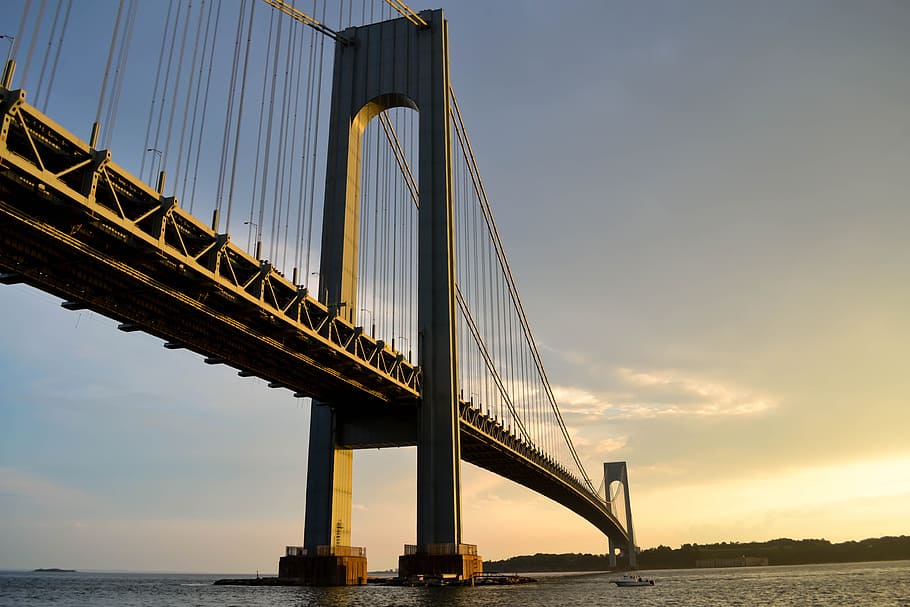 gray metal bridge across body of water, suspension bridge above body of water during golden hour HD wallpaper