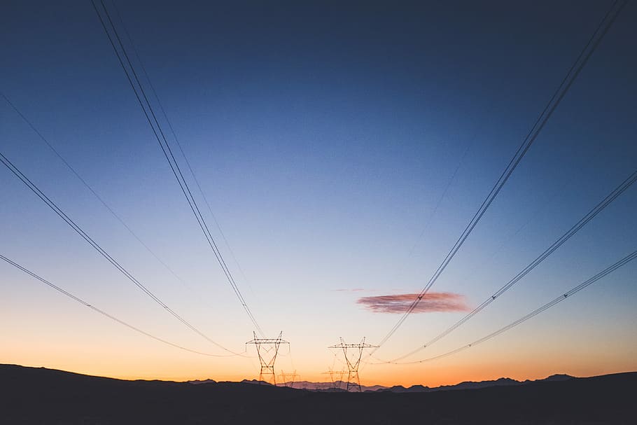 two transmission towers during golden hour, silhouette photography of transporter tower near trees HD wallpaper