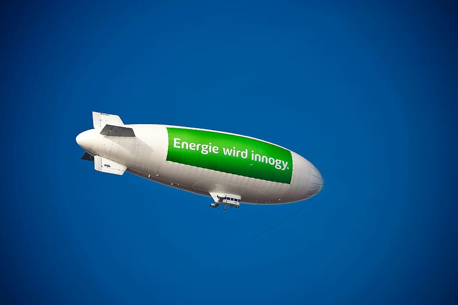 white and green Energie wird innogy-printed airship, zeppelin