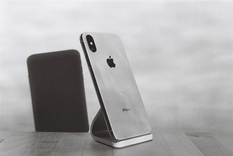 silver iPhone X on stand, silver iPhone X on table, mobile phone HD wallpaper