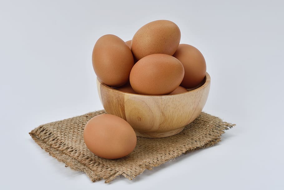 Brown Eggs on Brown Wooden Bowl on Beige Knit Textile, close-up HD wallpaper