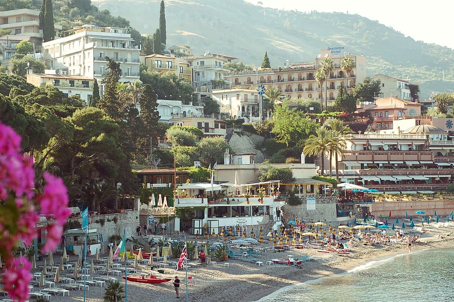 establishments near body of water, seashore near city, people HD wallpaper