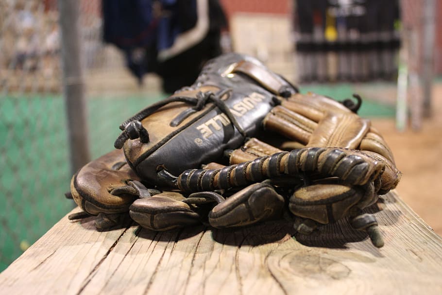 selective focus photography of baseball mitt on brown board HD wallpaper