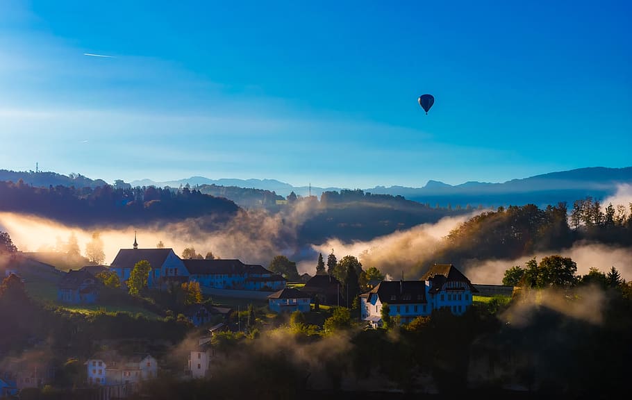 hot air balloon floating above village surrounded by fogs, fribourg, HD wallpaper