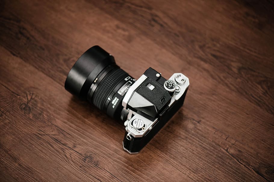 black and gray SLR camera, black and gray DSLR camera on brown wooden surface HD wallpaper