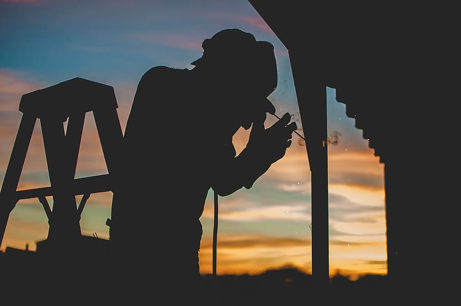 silhouette of person in shallow focus photography, silhouette of man welding on steel house pillar HD wallpaper