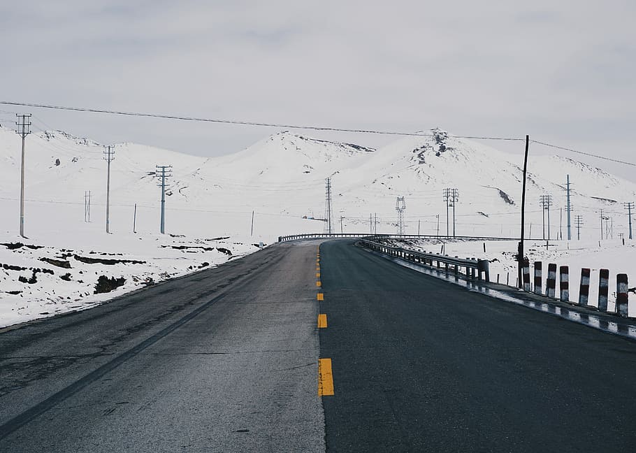 asphalt road, black concrete road near snow covered mountain HD wallpaper