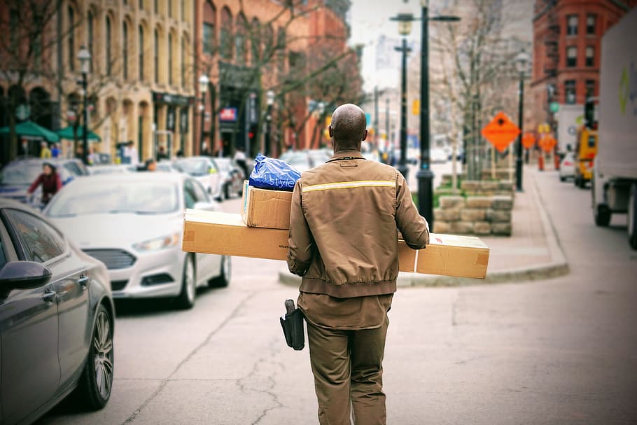 man in brown jacket beside car, man wearing brown jacket during daytime HD wallpaper