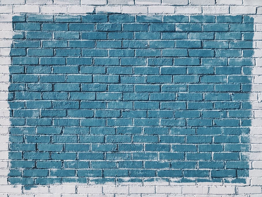 close-up photo of blue painted concrete brick wall, bricks, rocks