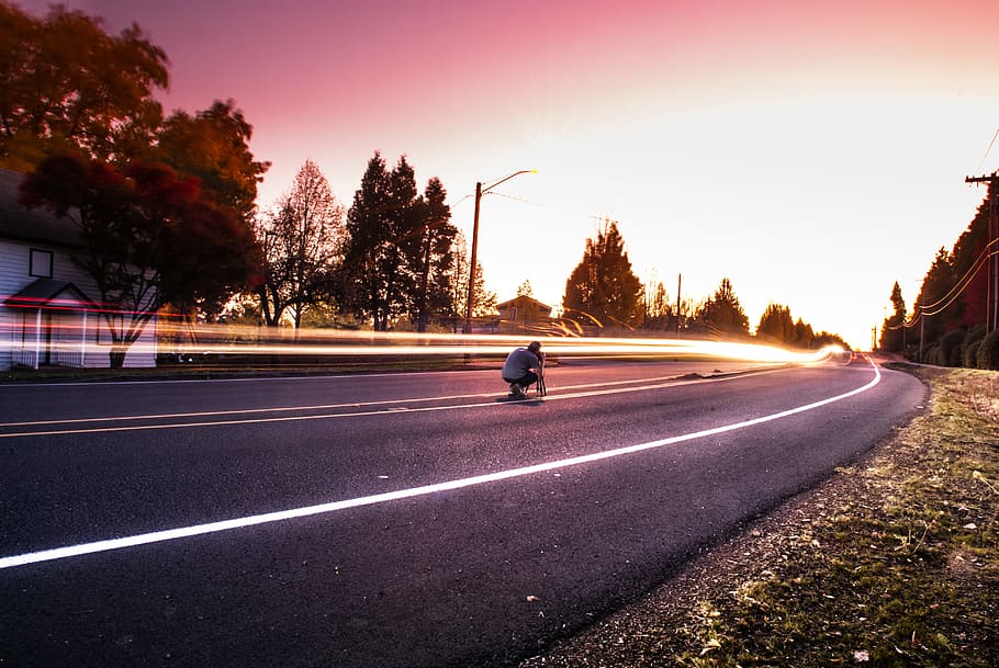 Person Sitting on Black Top Road during Twilight, asphalt, blur HD wallpaper