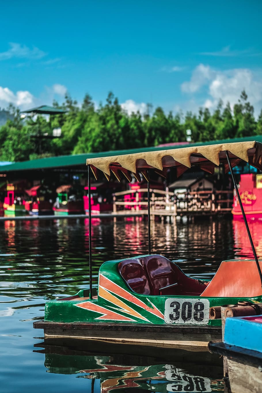 green and red 308 boat floating on water during daytime, green and brown floating cart with blue skies during day time HD wallpaper