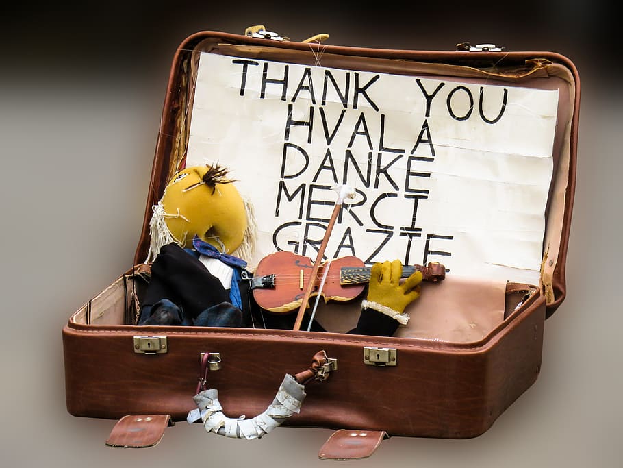opened brown briefcase with miniature violin, puppet, doll HD wallpaper