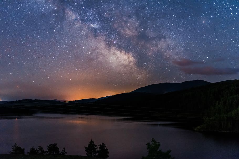 landscape photo of mountains beside body of water, lake surround by mountains under sky with stars HD wallpaper
