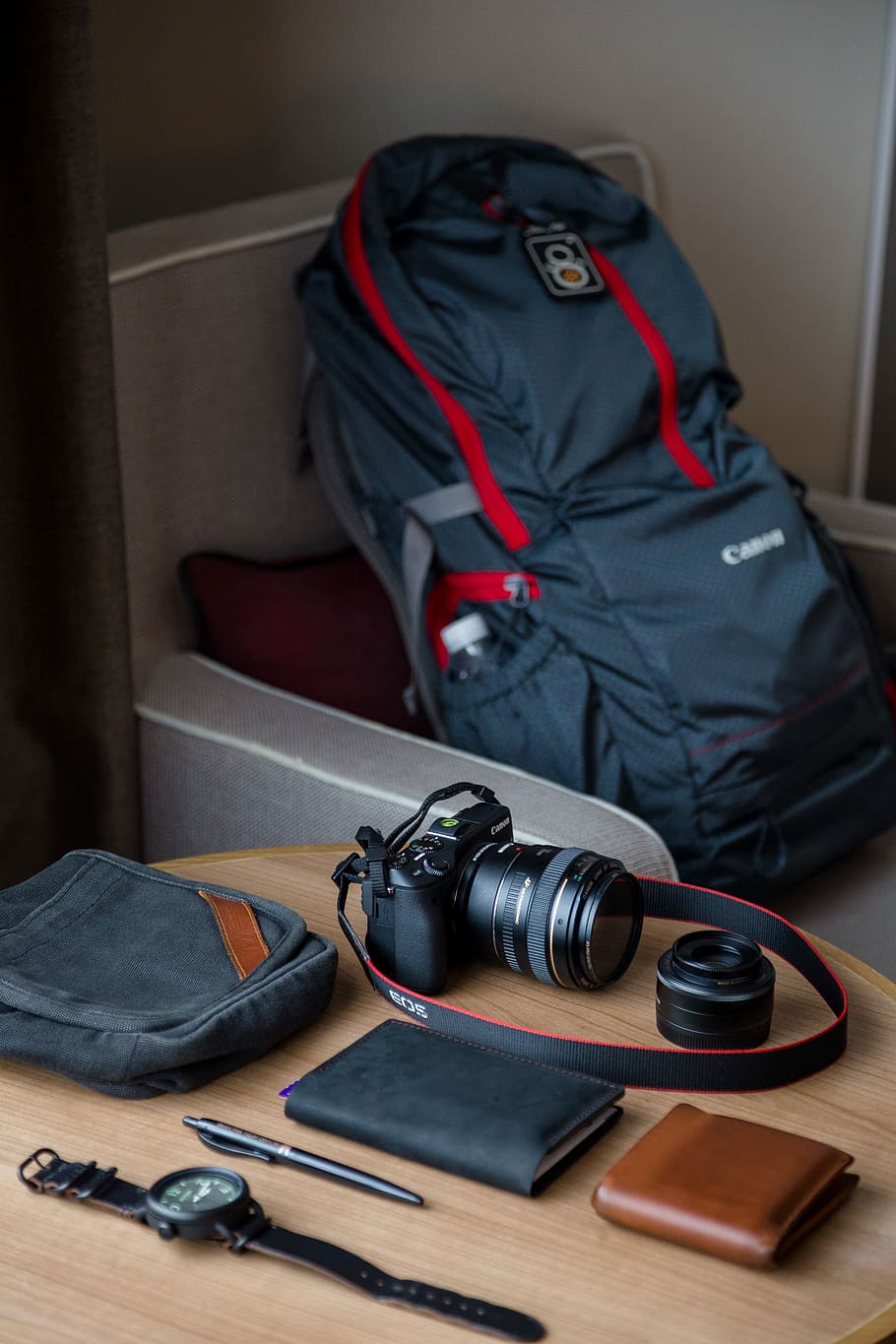 Canon DSLR camera on top of table, black DSLR camera beside leather notebook, brown wallet, click pen, and watch place on table HD wallpaper