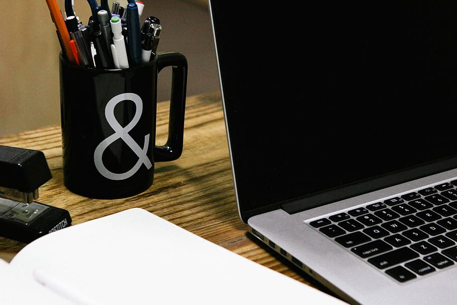 black and gray laptop near black ceramic mug, laptop computer turned off HD wallpaper