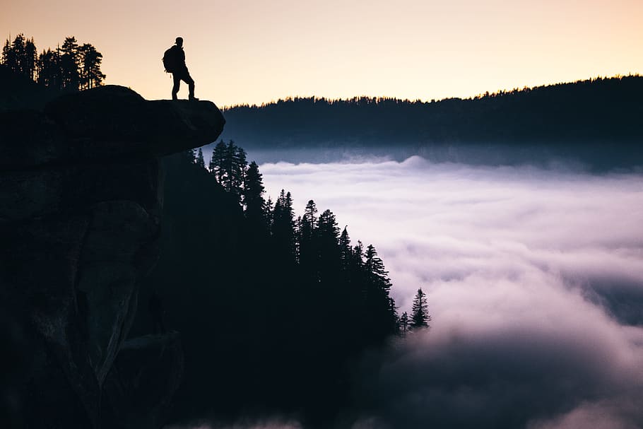 silhouette photo of man standing in mountain overlooking trees at daytime, Glacier Point
