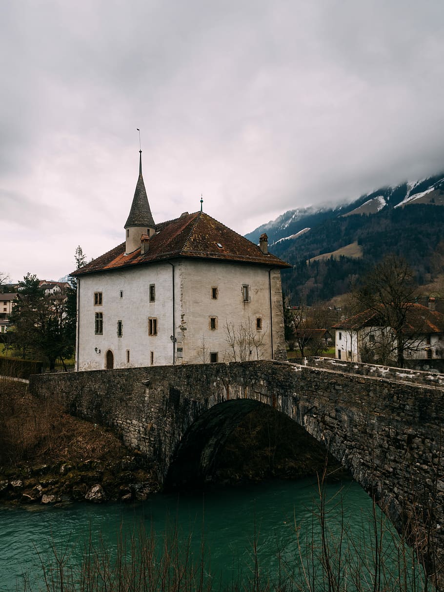 Broc, Switzerland, bridge to white concrete house near mountain HD wallpaper