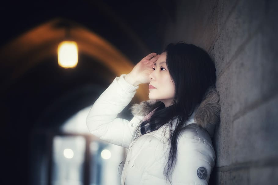 Lost in momeries, woman in white parka jacket standing beside gray wall HD wallpaper