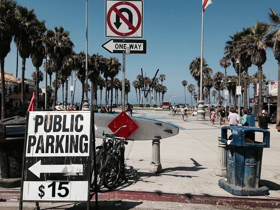 two bicycles parked near trash can, white and black Public Parking $15 sign HD wallpaper
