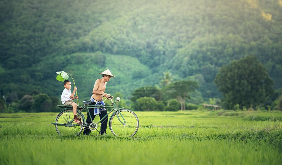 man holding gray bike, bicycle, his son, seat, cambodia, relationship