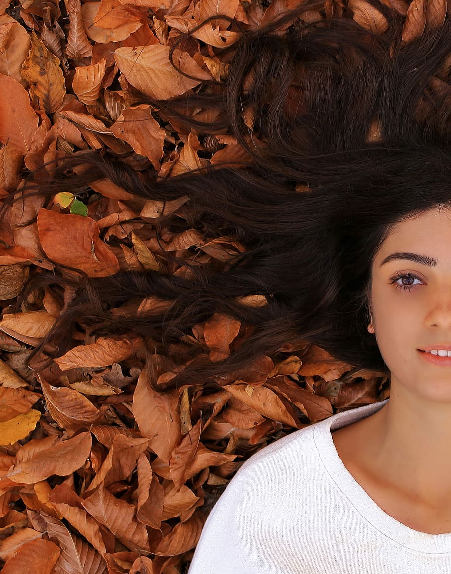 Autumn, woman lying on dry leaves, leaf, fall, face, young adult HD wallpaper