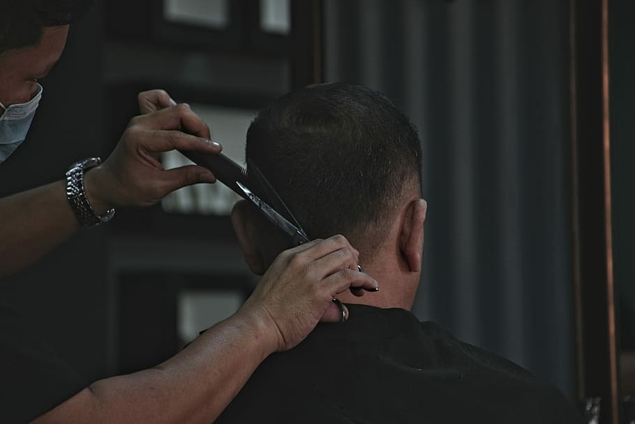barber cutting man's hair, man cutting hair of man, haircut, barber shop