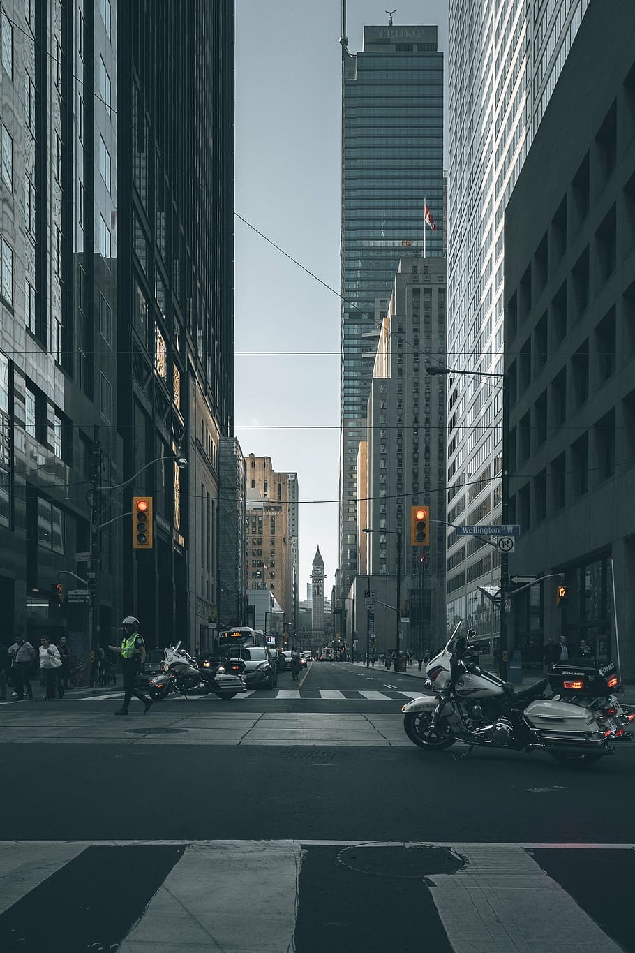 white and black touring motorcycle on street near high-rise buildings HD wallpaper
