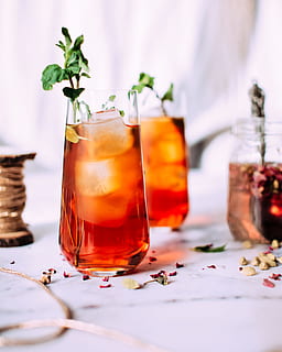 red liquid with ice and plant, ice tea in clear drinking glass HD wallpaper