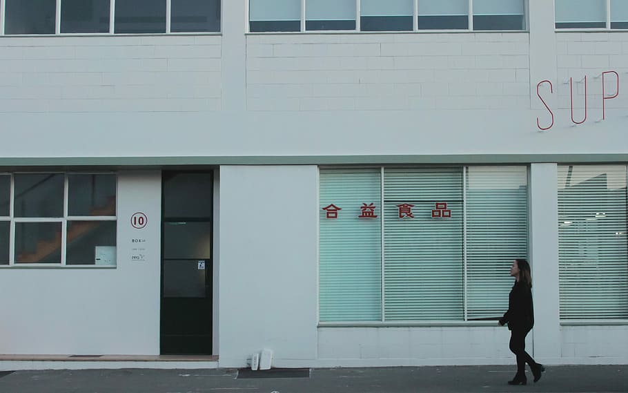 woman walking beside sidewalk, building, white, window, door HD wallpaper