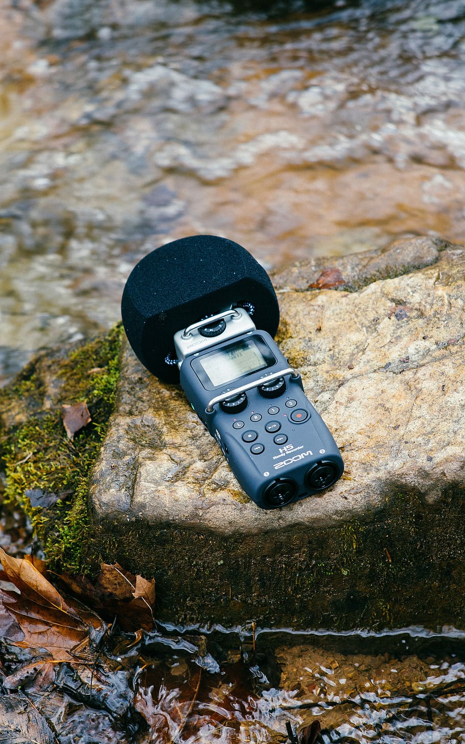 black digital wireless microphone on mossy rock, black digital device on rock HD wallpaper