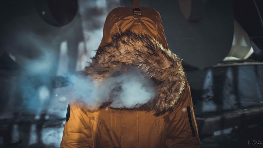 person in brown coat, smoke coming out from brown fur coat, parka