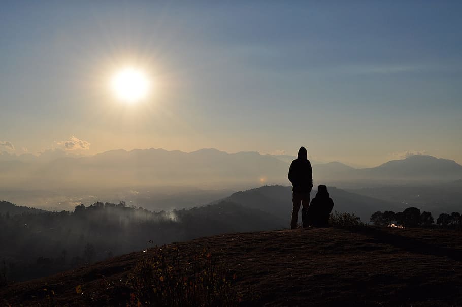silhouette of two person on cliff, sunset, people, mountains HD wallpaper