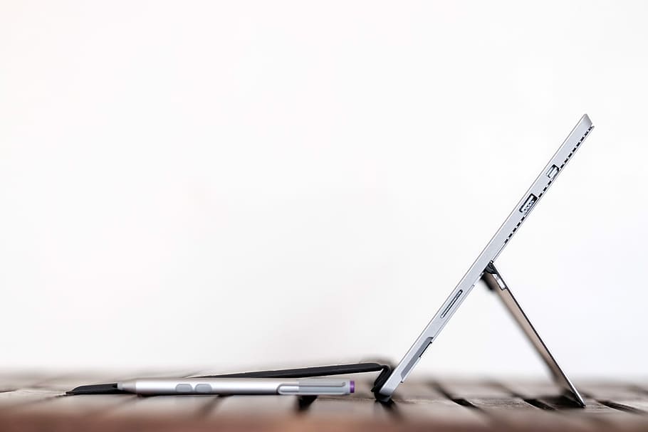 stylus pen in front of table computer, side view of gray tablet computer with white background HD wallpaper