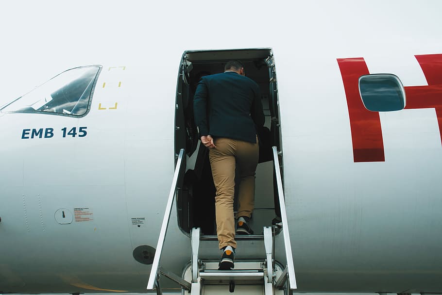 man entering plane during daytime, man in red and white airliner, HD wallpaper
