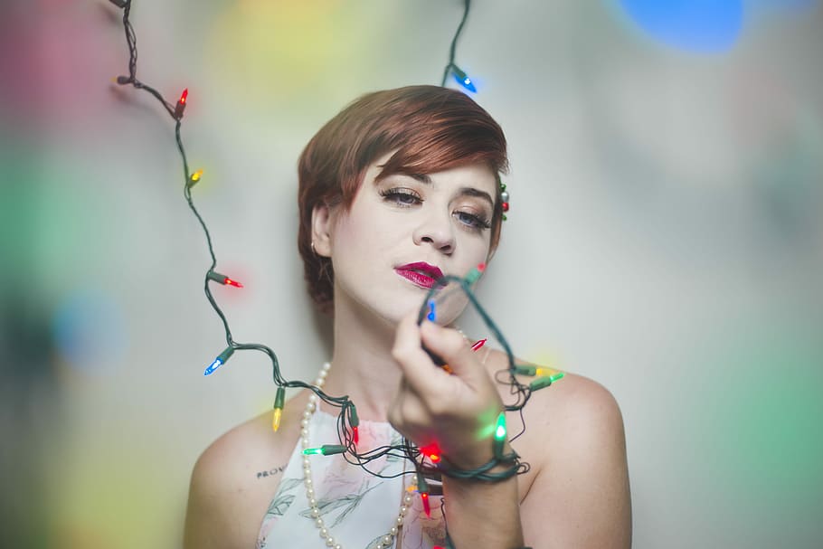 Christmas Allure, woman lean back on the wall holding string lights, HD wallpaper