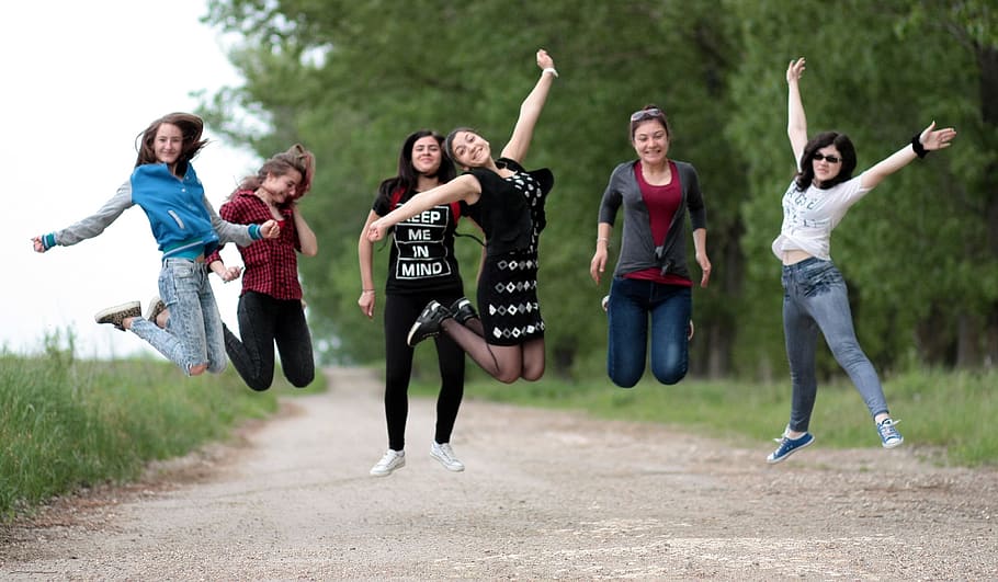 group of woman having jump shot photography during daytime, girls