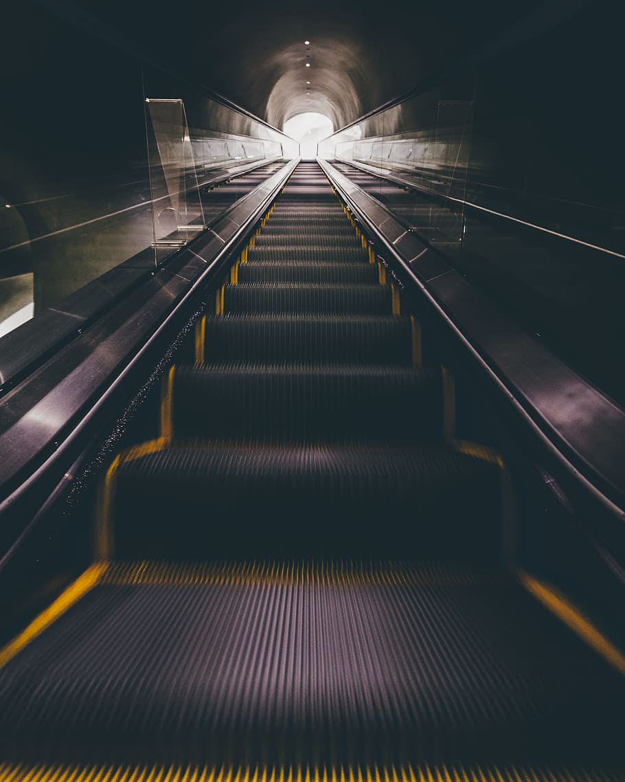 escalator moving upward, low angle photography of black escalator HD wallpaper
