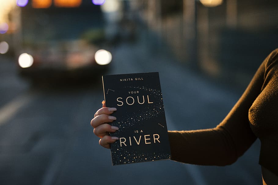 person holding Your Soul is a River book, woman holding Soul is a River book HD wallpaper