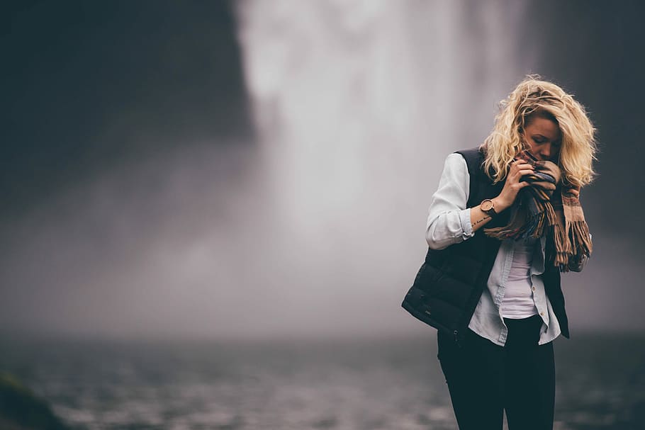 woman standing in front of waterfall, woman wearing black vest and white dress shirt near waterfalls shallow focus photography during daytime, HD wallpaper
