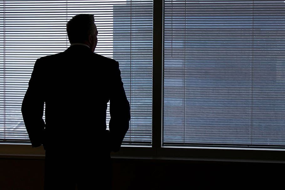 man standing in front of building window, business, business man
