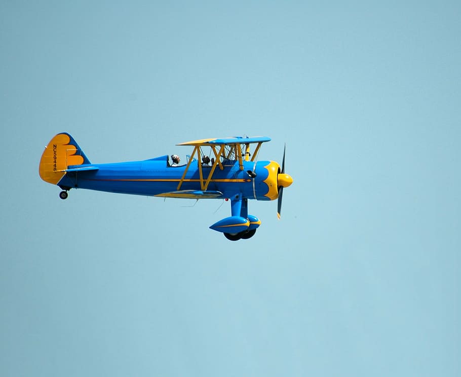 closeup photo of blue and yellow plane, vintage, airplane, bi-plane
