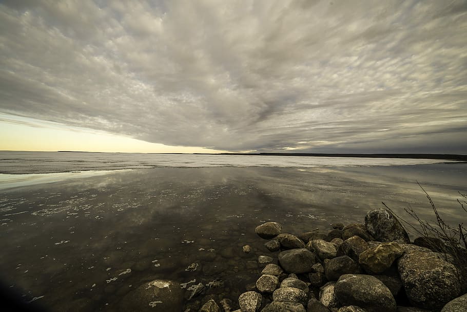 Lakeshore Landscape under Cloudy Dramatic Skies at dusk on Great Slave Lake HD wallpaper