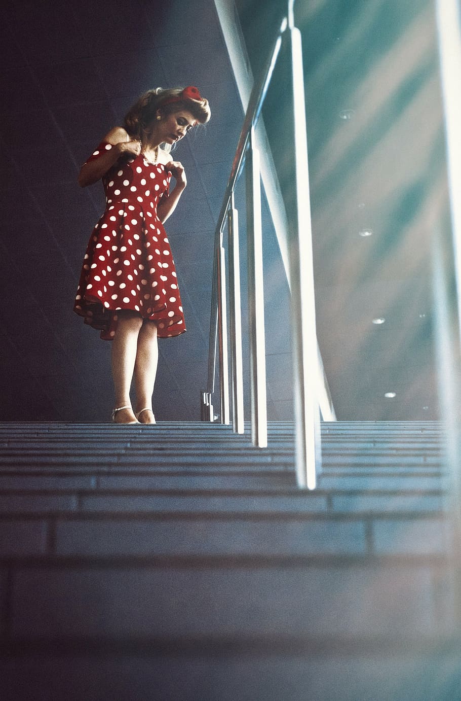 woman in white and red polka-dot dress near handrail, girl, pin-up girl