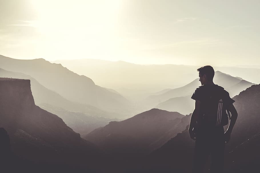 man standing on top of cliff during daytime, guy, people, mountains HD wallpaper